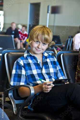 boy is waiting for departure at the airport
