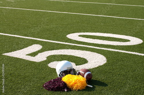 American Football Equipment and Pom Poms on Field photo