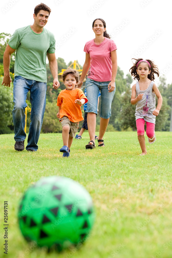 Family playing football in the park Family playing football in the park