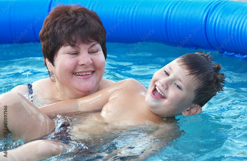 grandmother with a grandchild in a pool