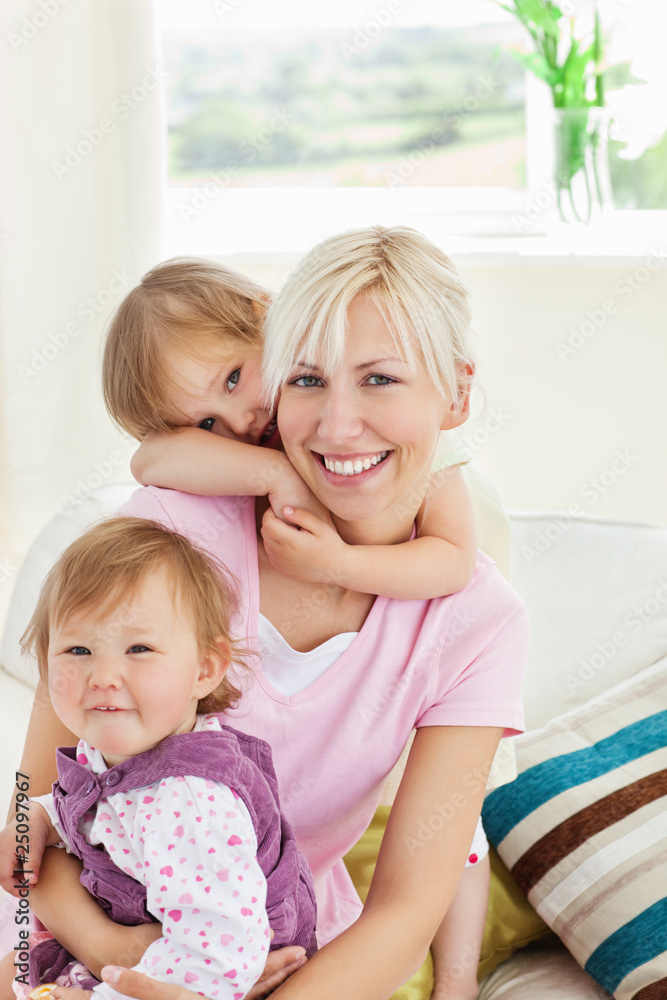 Smiling little girls embracing her mother