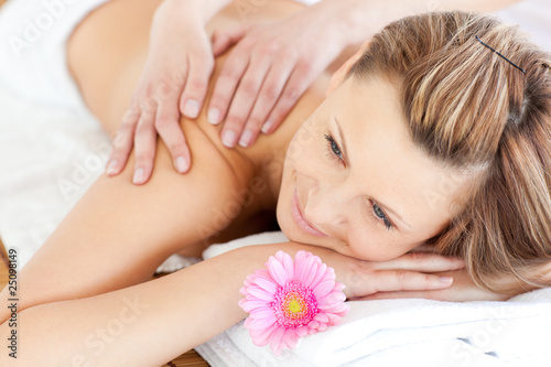 Blissful young woman enjoying a back massage