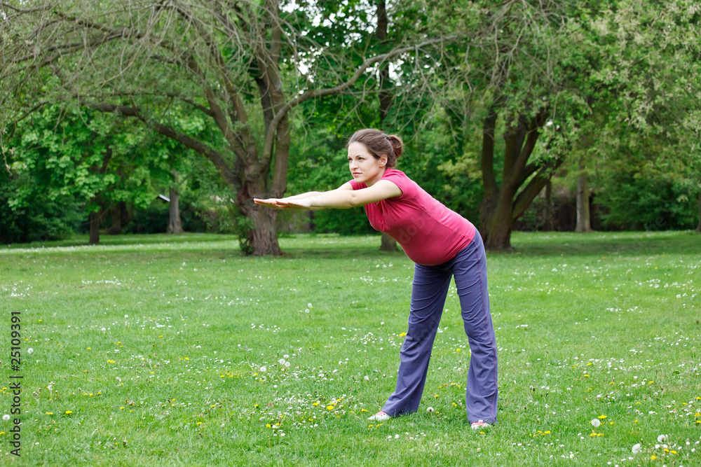 Pregnant woman exercising in the park