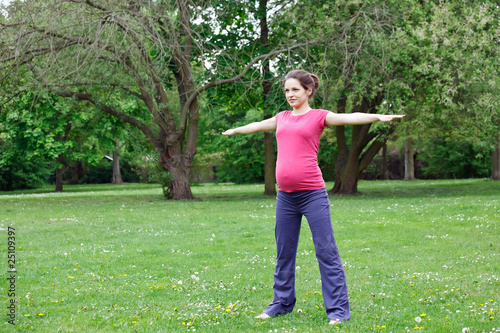 Pregnant woman exercising in the park