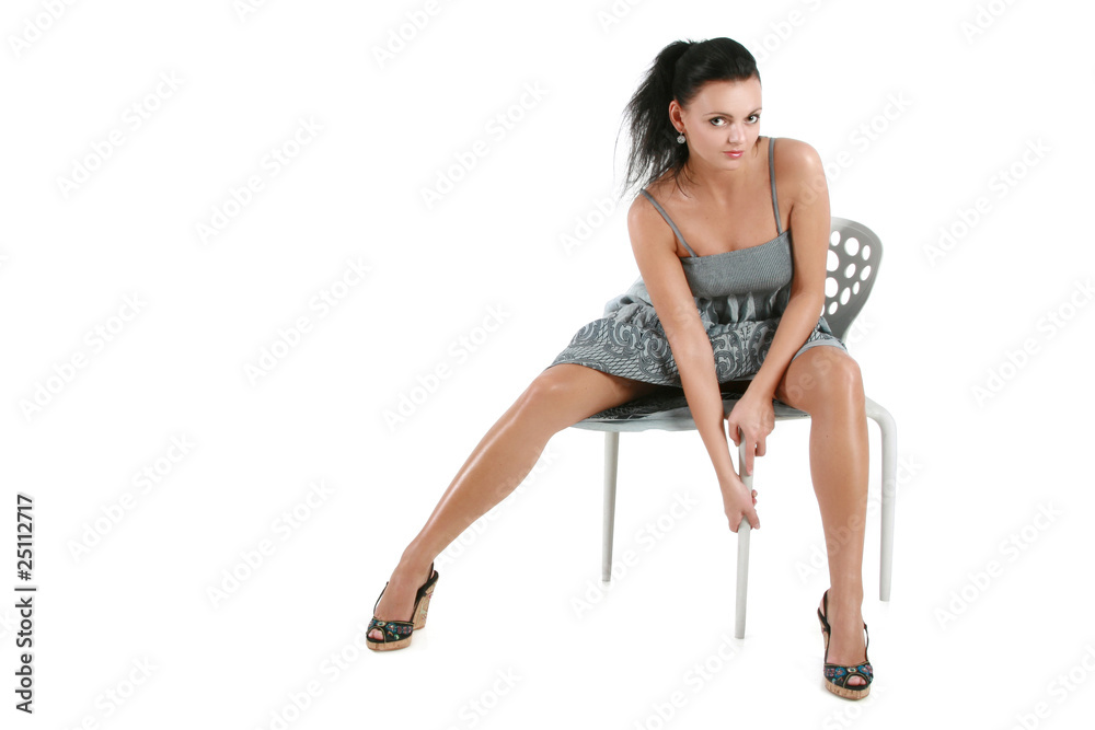 Young woman in black dress posing in studio. Isolated on white Young woman in black dress posing in studio. Isolated on white