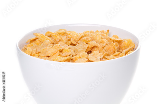 Bowl with corn flakes and milk on the white background