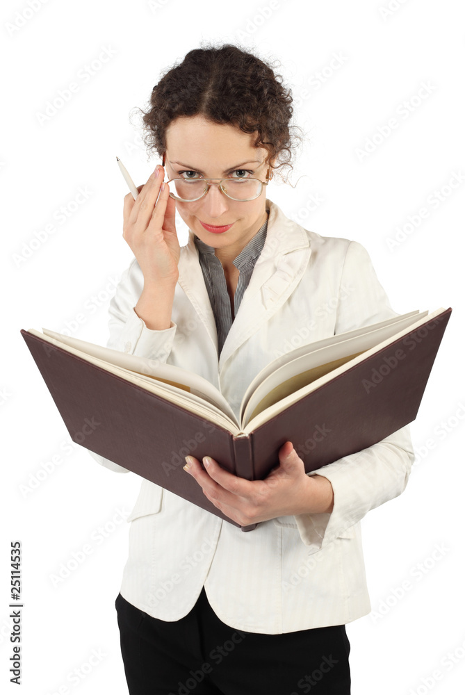 young serious woman arranging glasses and holding big book young serious woman arranging glasses and holding big book