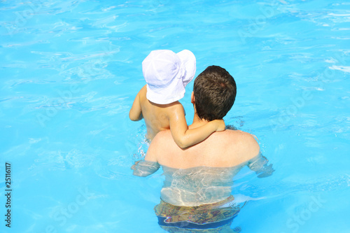 Father and daughter in the pool