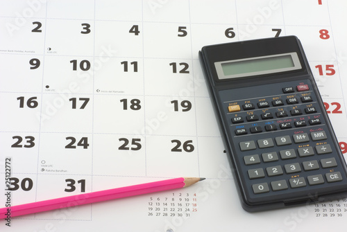 Calculator and pencil on the calendar