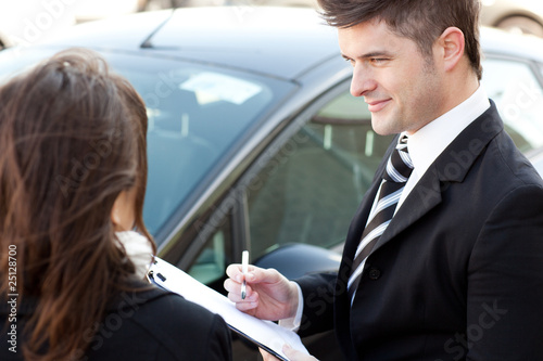 Confident businessman undersign a car contract photo