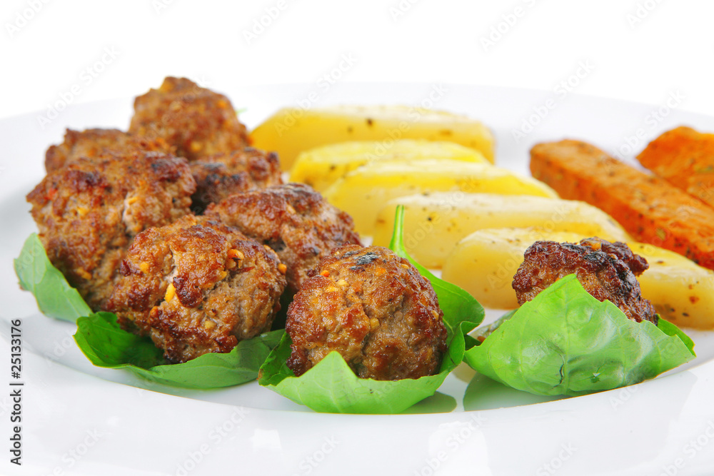 served meatballs on basil leaf
