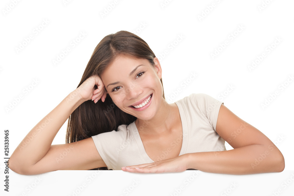 Woman leaning on blank white billboard sign Woman leaning on blank white billboard sign