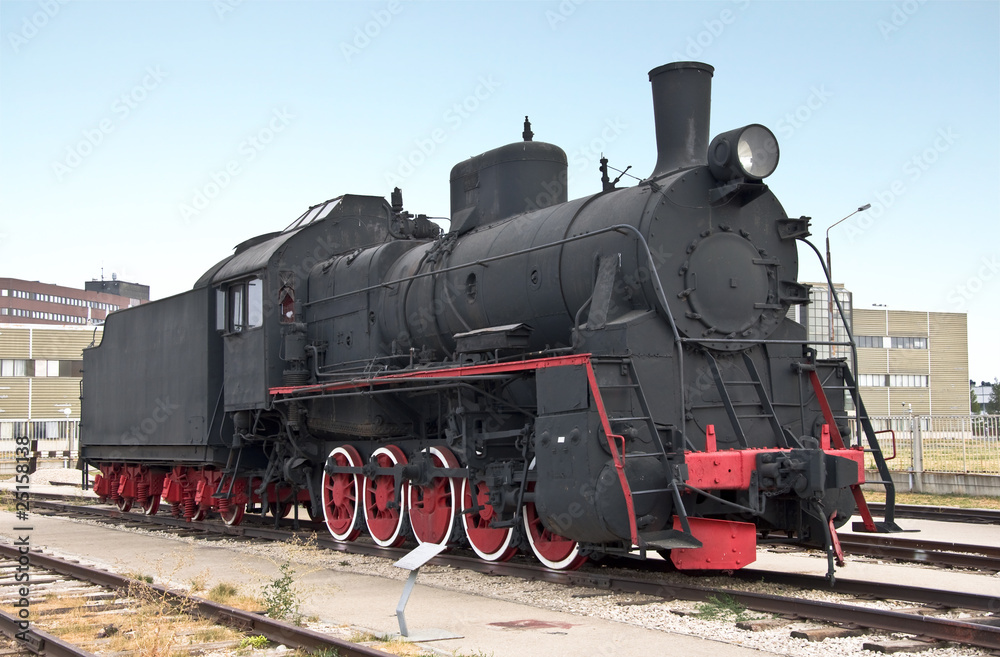 Steam locomotive beside a railway station platform. Retro train. Steam locomotive beside a railway station platform. Retro train.