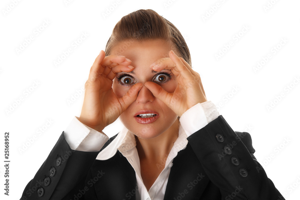 business woman making binoculars with hands and looking through