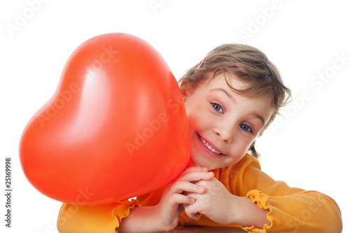 laughing girl holds heart shape balloon isolated
