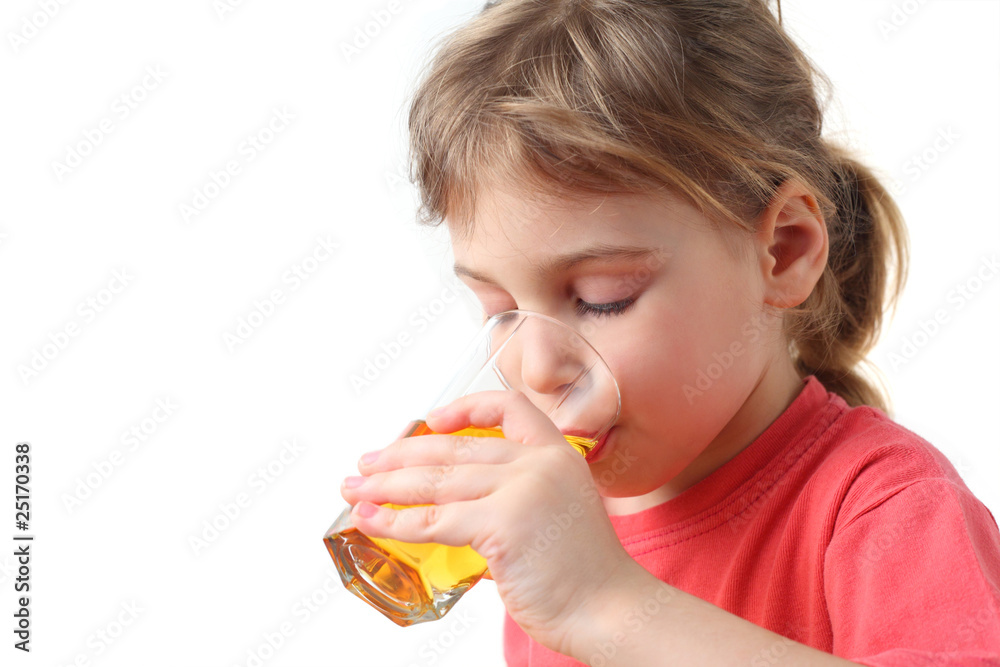 little girl in red shirt holding glass with juice for one hand