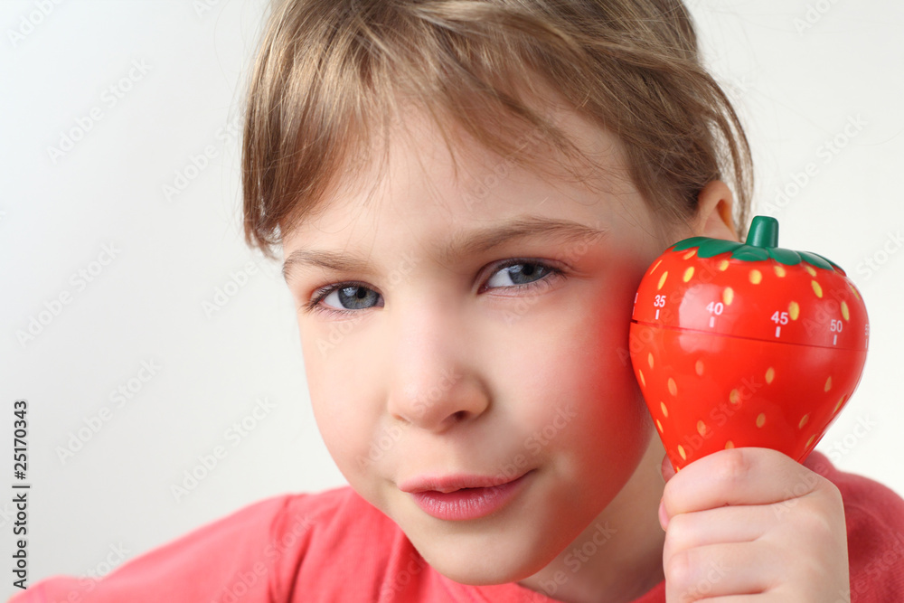 little girl in red shirt holding in hand plastic kitchen timer little girl in red shirt holding in hand plastic kitchen timer