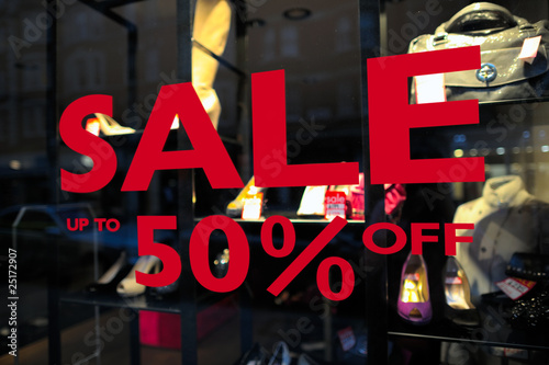 Sale (up to 50% off) sign in a fashion shop window