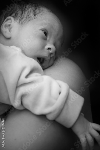 Newborn on mothers shoulder