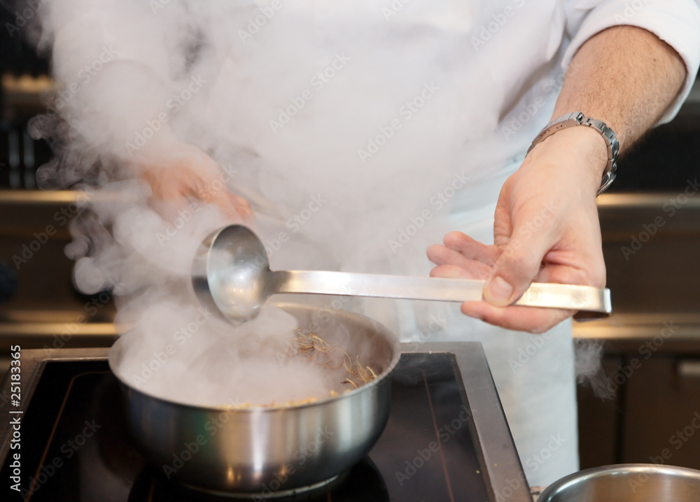 Chef cooking at the commercial kitchen Chef cooking at the commercial kitchen