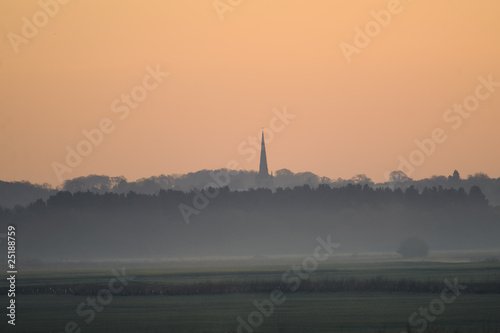 misty landscape with church in the distance