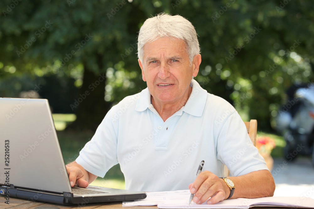 Closeup of senior man with laptop computer at home Closeup of senior man with laptop computer at home