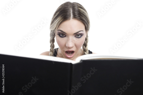 young pretty girl reading a book