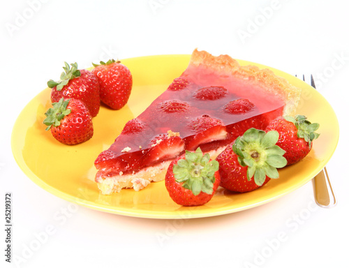 Piece of Strawberry Tart on a yellow plate with strawberries