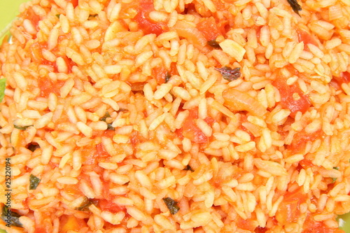 Food background: Risotto with tomatoes in close up
