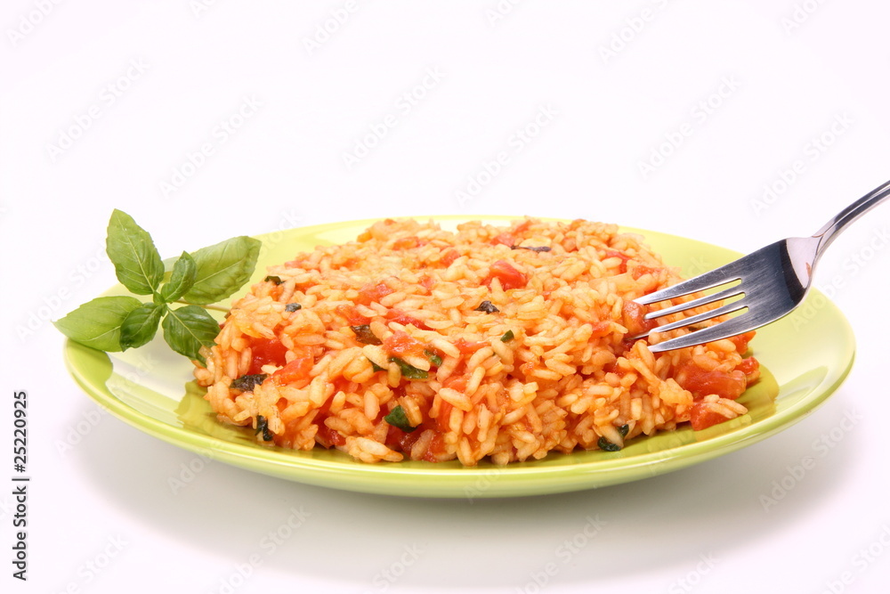 Risotto with tomatoes being eaten with a fork Risotto with tomatoes being eaten with a fork