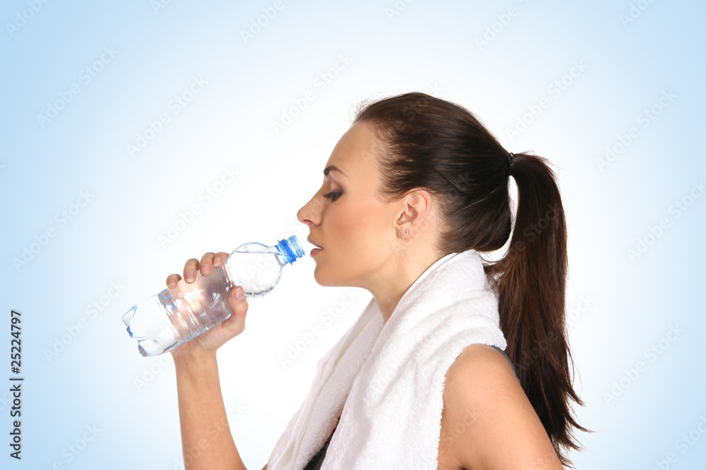 Young attractive female sportsman drinking water Young attractive female sportsman drinking water