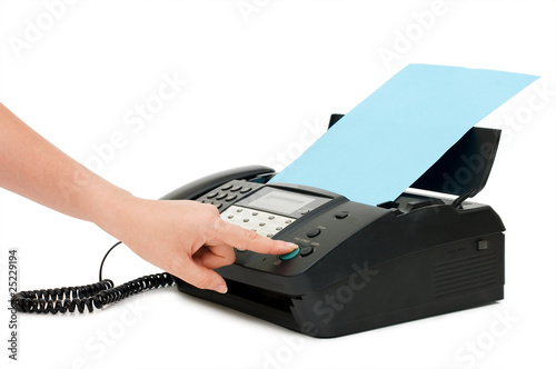 The hand presses the fax button