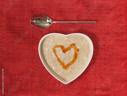 porridge in a heart shaped bowl with honey photo