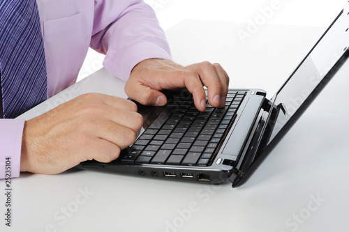 Hands on the laptop keyboard.