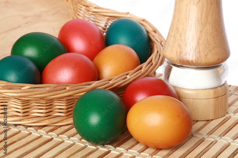 Naklejka premium Colour Easter eggs in a wattled basket