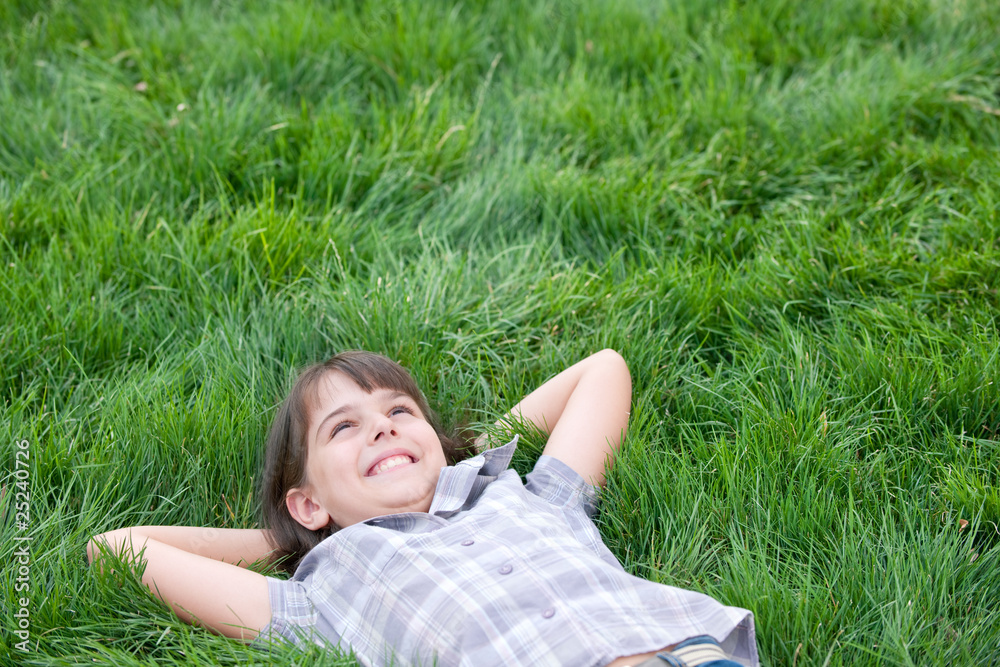 Happy girl lying on the grass Happy girl lying on the grass