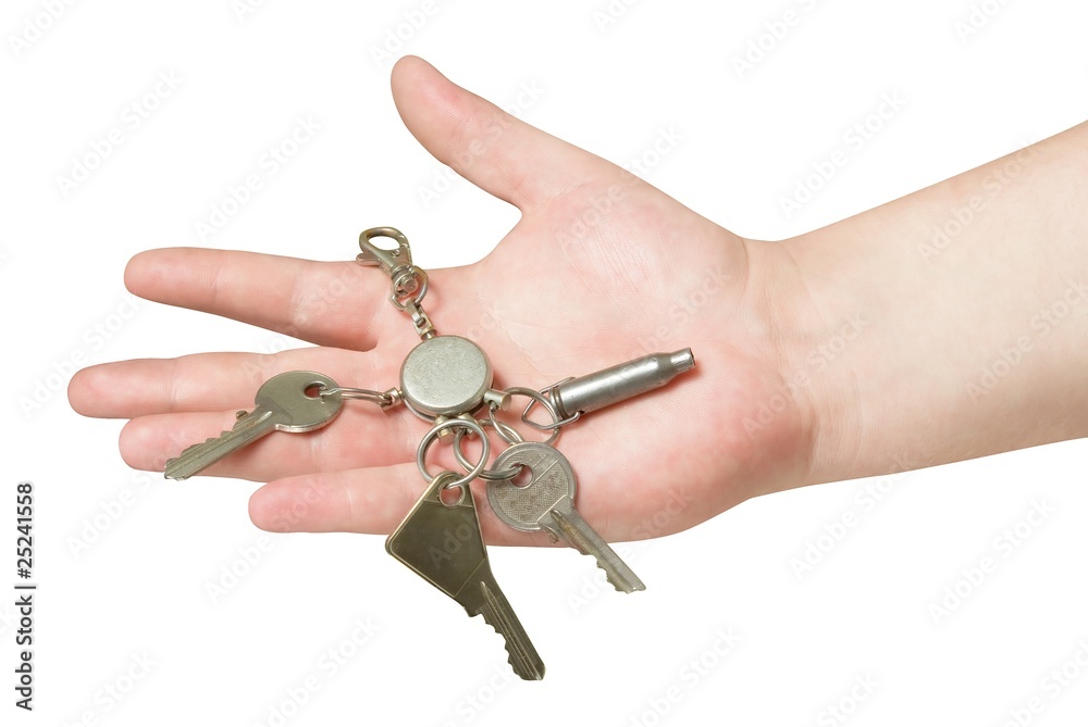 key trinket in human hand isolated with clipping path. key trinket in human hand isolated with clipping path.