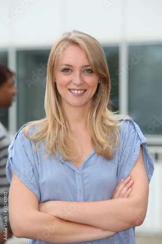 Closeup of beautiful blond woman with arms crossed
