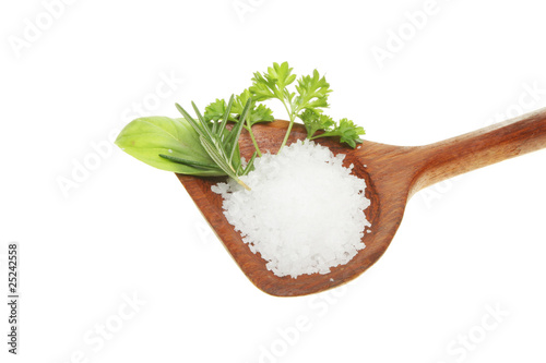 Sea salt and fresh green herbs in a spoon photo