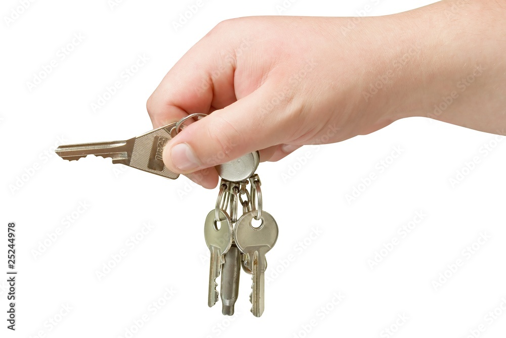 key trinket in human hand isolated with clipping path