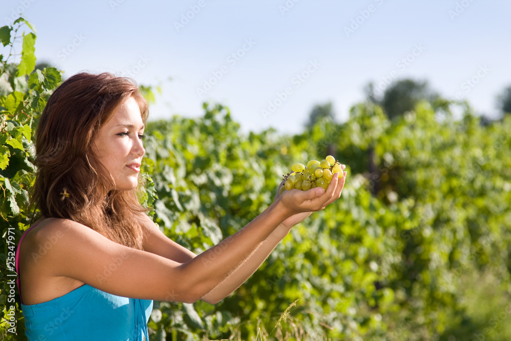 Young woman with green grapes in the hands Young woman with green grapes in the hands