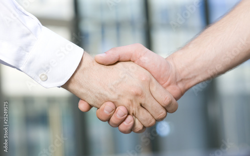 Handshake between office workers