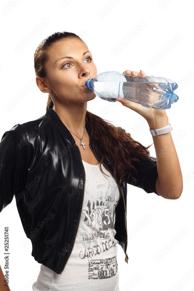 Beautiful woman drinking mineral water isolated Beautiful woman drinking mineral water isolated