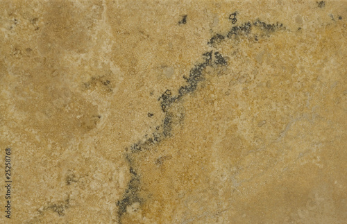 Surface of the travertine. Tints of brown and beige.