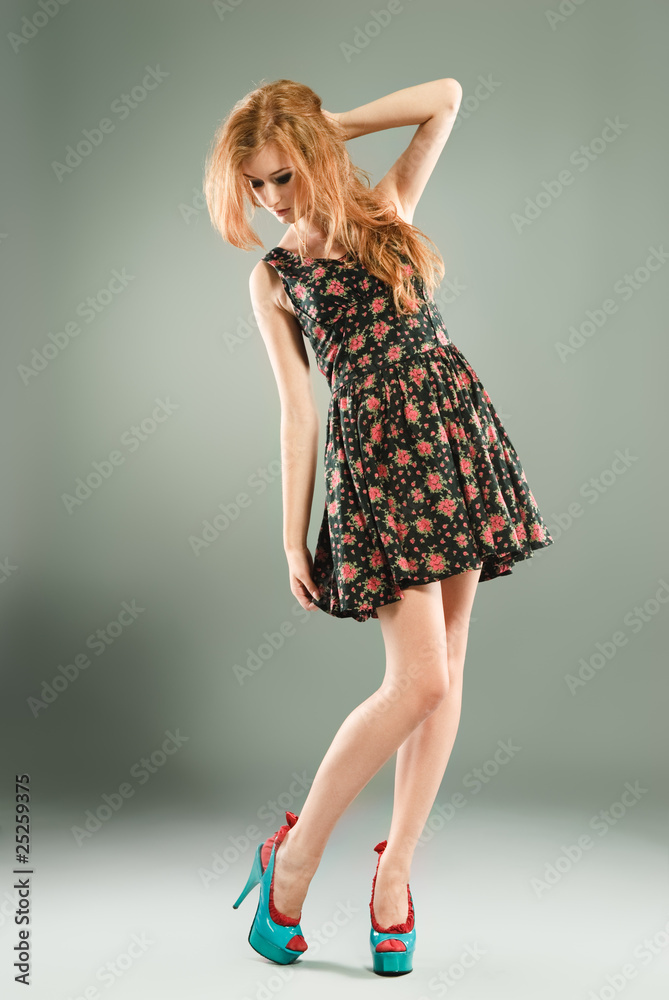 Beautiful red-haired girl on grey background Beautiful red-haired girl on grey background