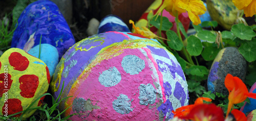 Large painted rocks in a flower garden.