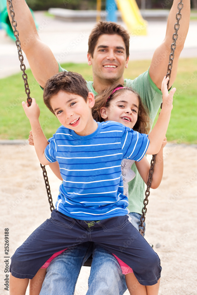 Father and children enjoying swing ride Father and children enjoying swing ride