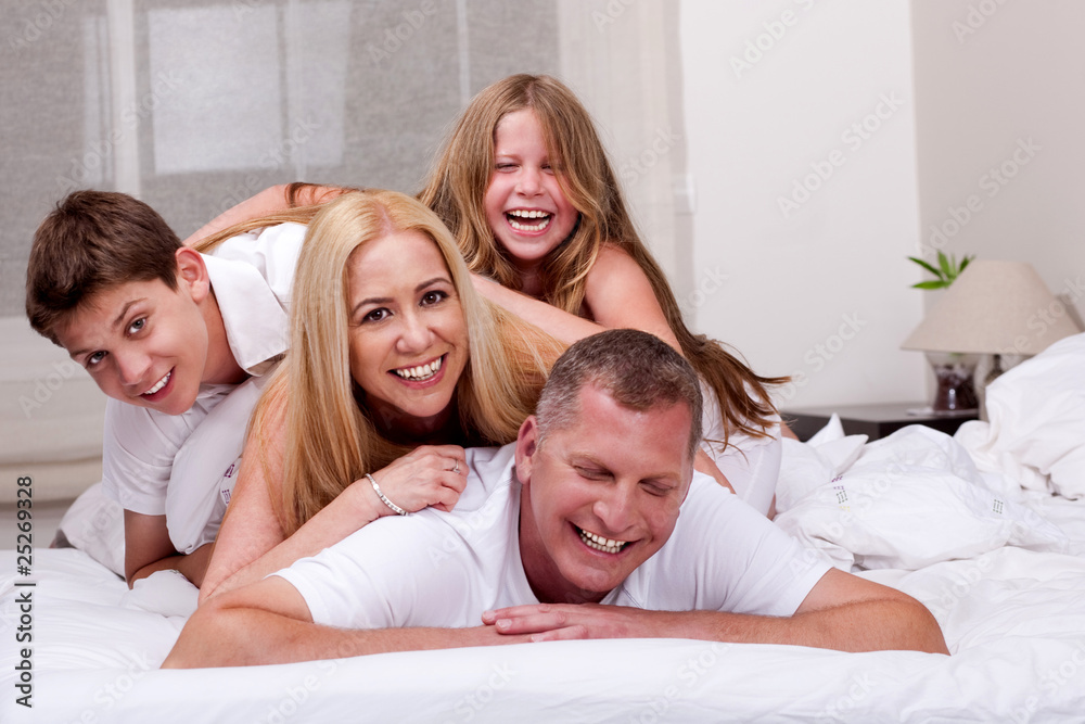 Family having fun in bed