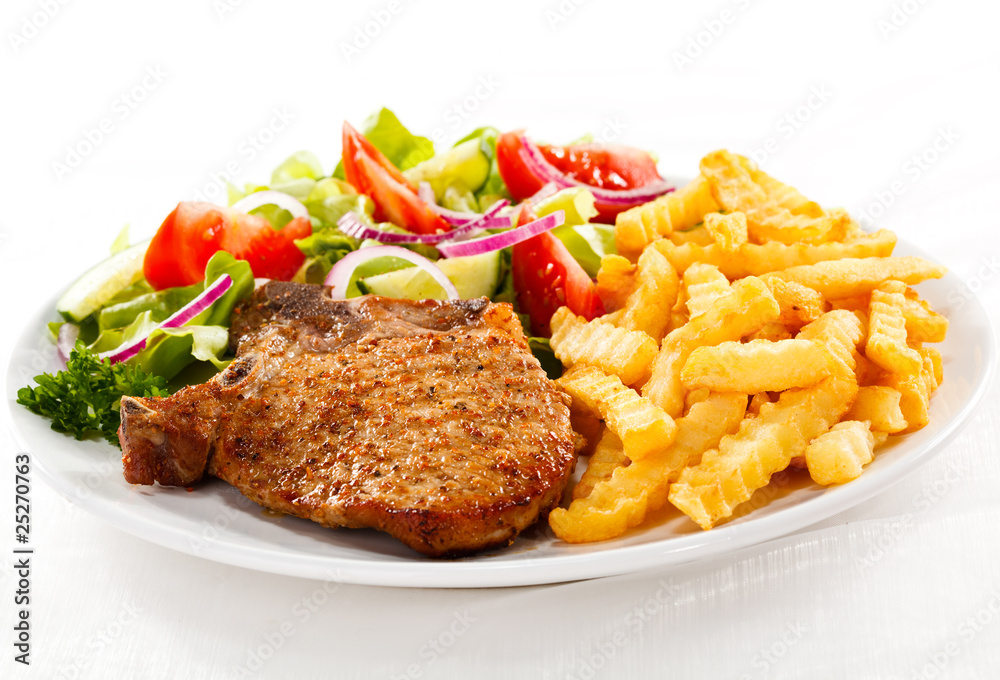 Fried pork chop with chips and vegetables
