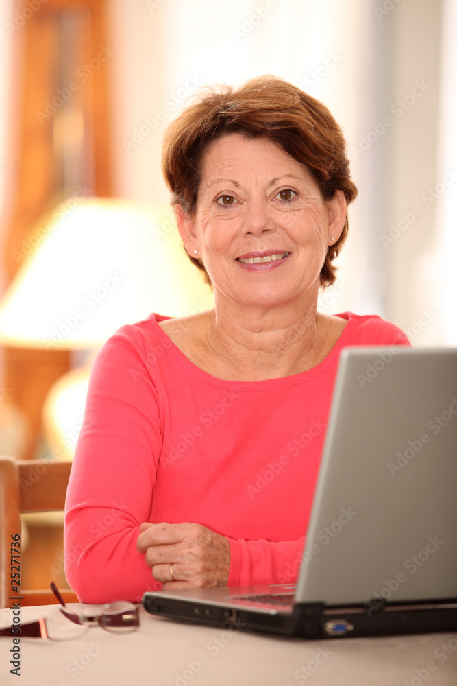 Closeup of senior woman at home with laptop computer Closeup of senior woman at home with laptop computer